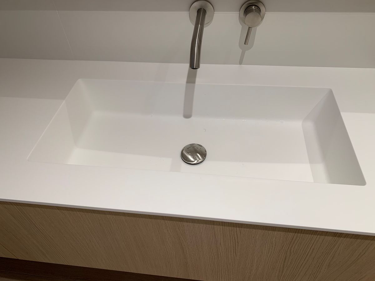 Un lavabo de salle de bain avec deux robinets et un drain.