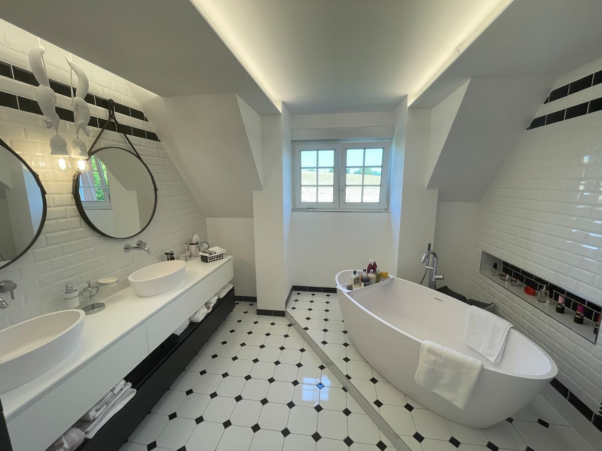 Une salle de bain avec deux lavabos et une baignoire.