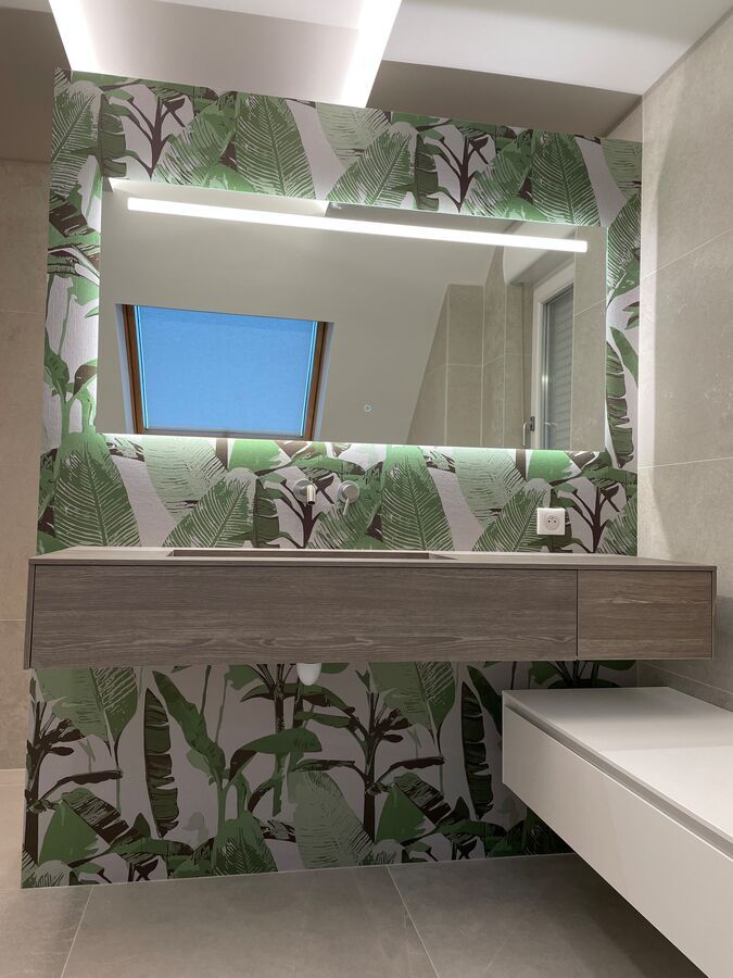 Une salle de bain avec un lavabo et un grand miroir