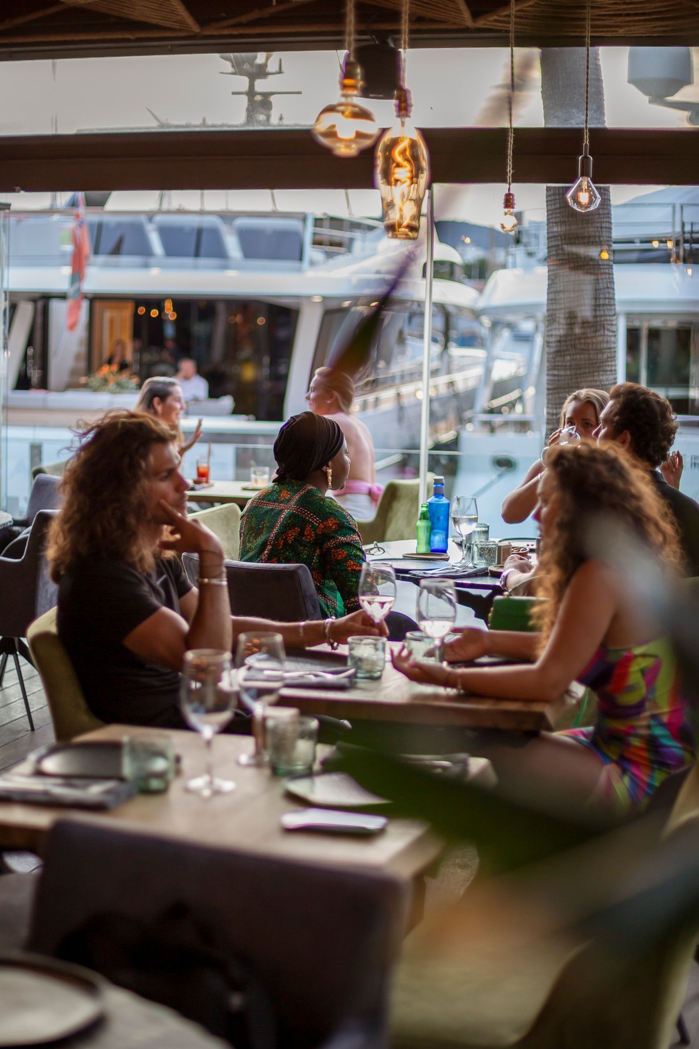 A group of people are sitting at tables in a restaurant