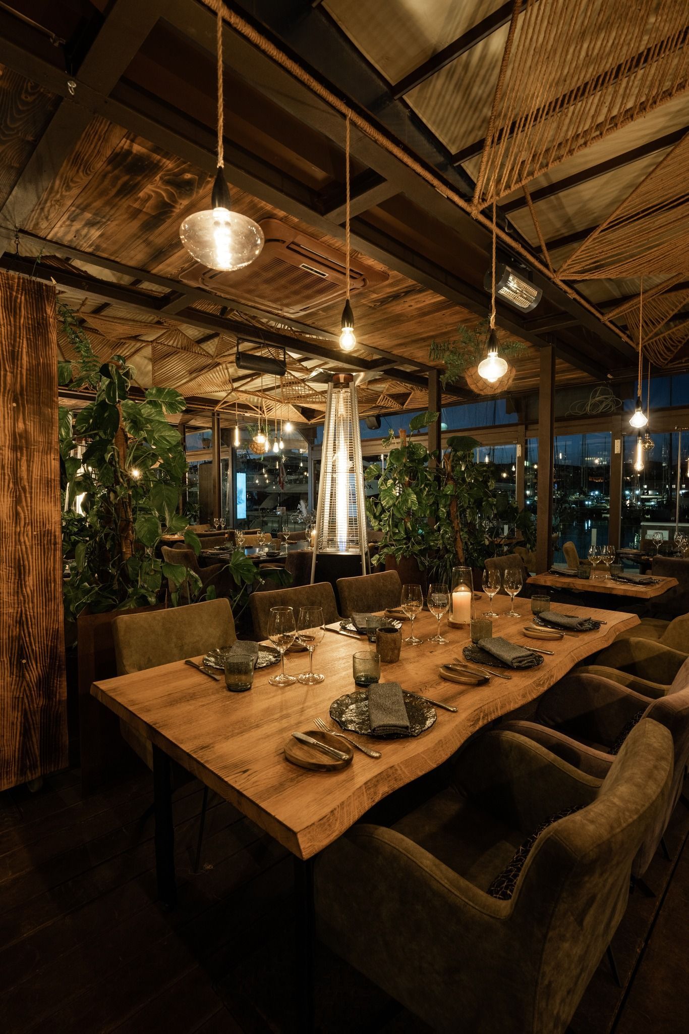 A restaurant with a long wooden table and chairs