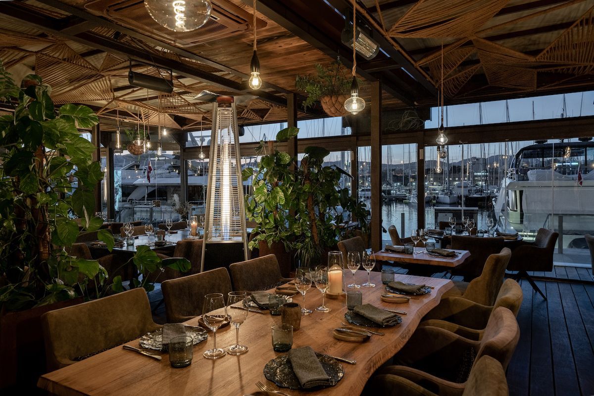 A restaurant with a large wooden table and chairs
