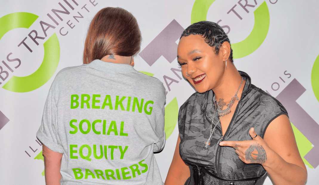 A woman wearing a shirt that says breaking social equity barriers