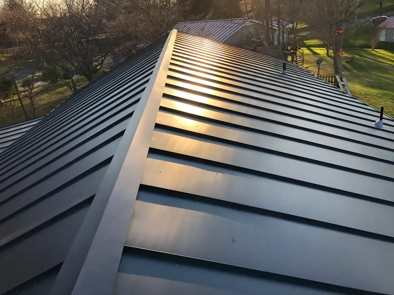 Dark metal roof reflecting sunlight.