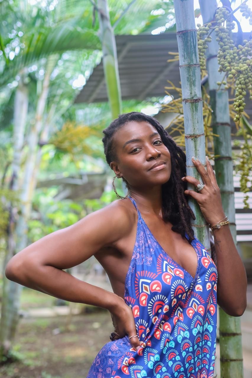 Amber leaning against bamboo at a retreat.