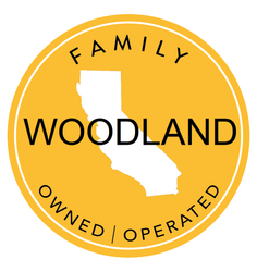 A yellow sticker that says family woodland owned operated