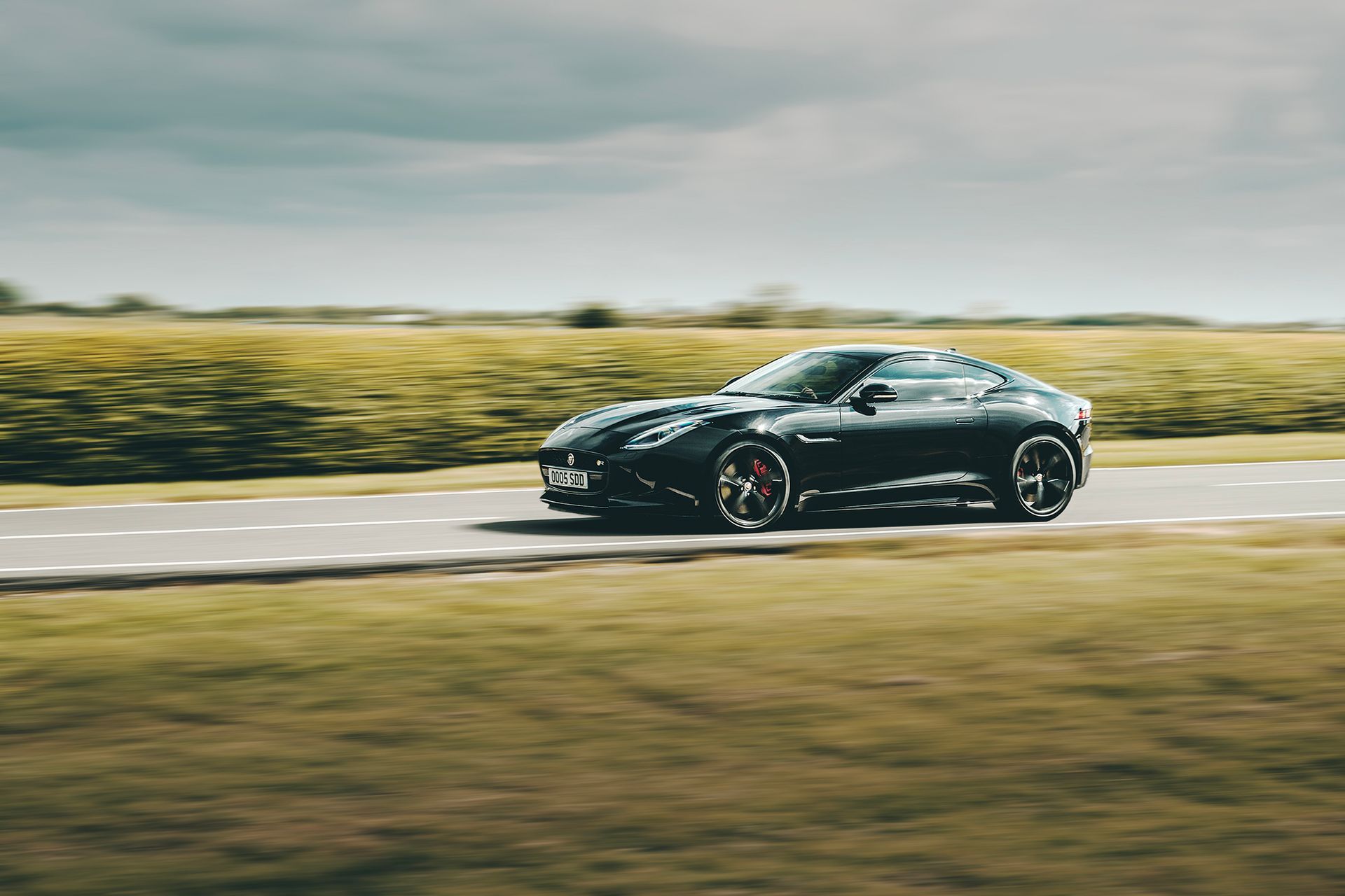 A Jaguar F Type driving down a road shot by Dammo Photography