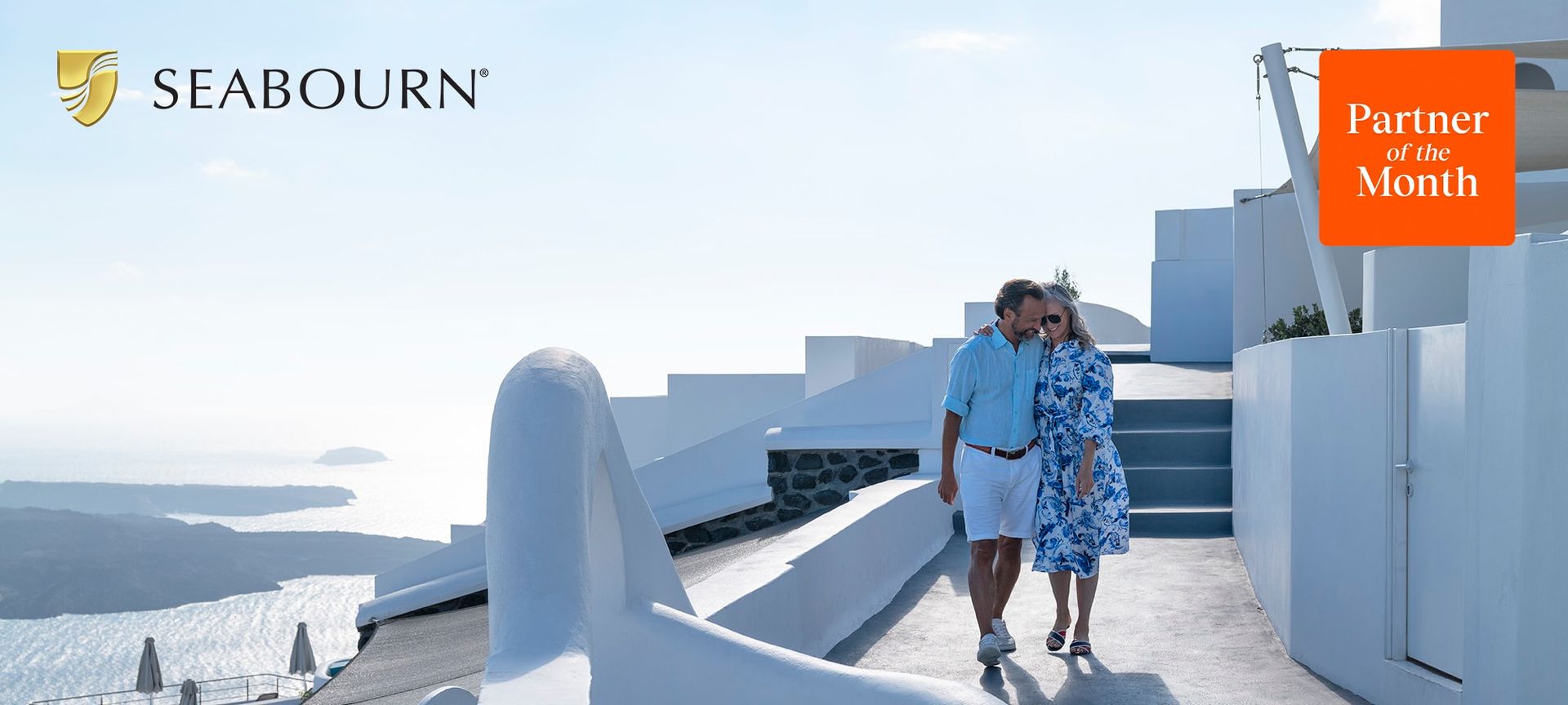 A man and a woman are walking down a sidewalk with a seabourn logo in the background