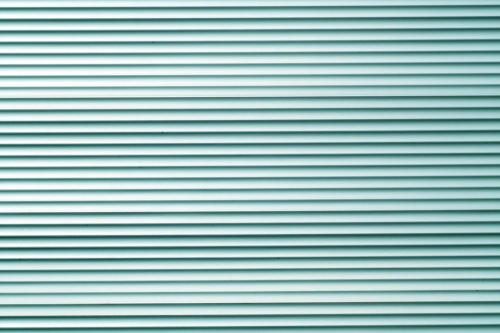 Horizontal rows of aqua-colored blinds.