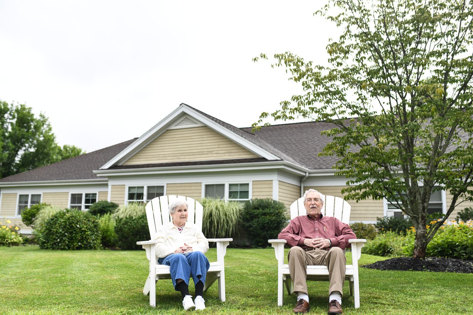 Residents relaxing on the front porch of Bellamy Assisted Living community