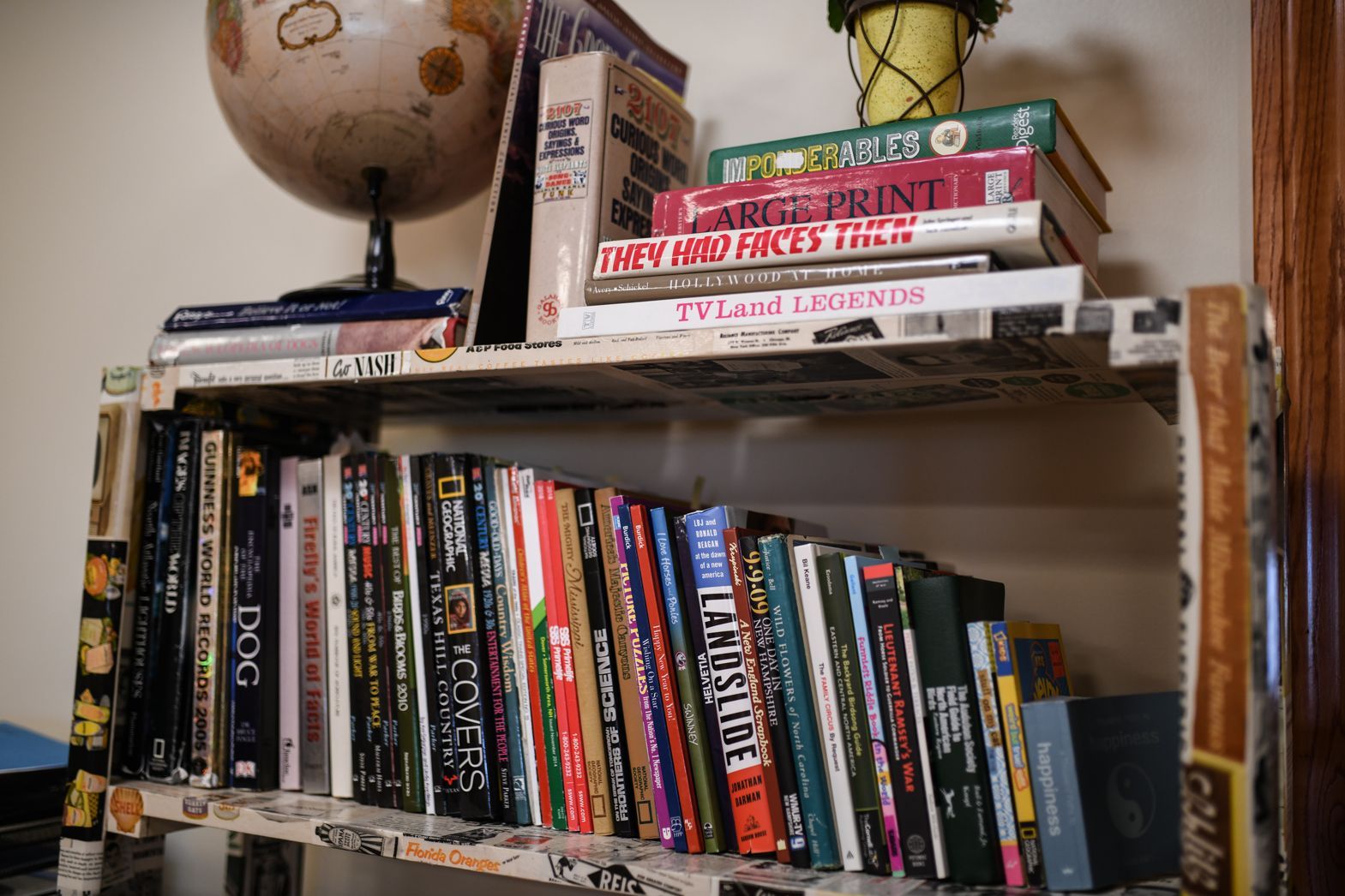 Bookshelf with novels and board games inside Bellamy Assisted Living community living area