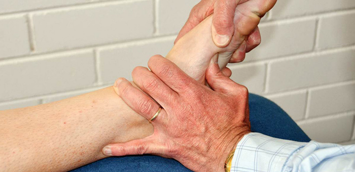A person is giving a foot massage to another person.