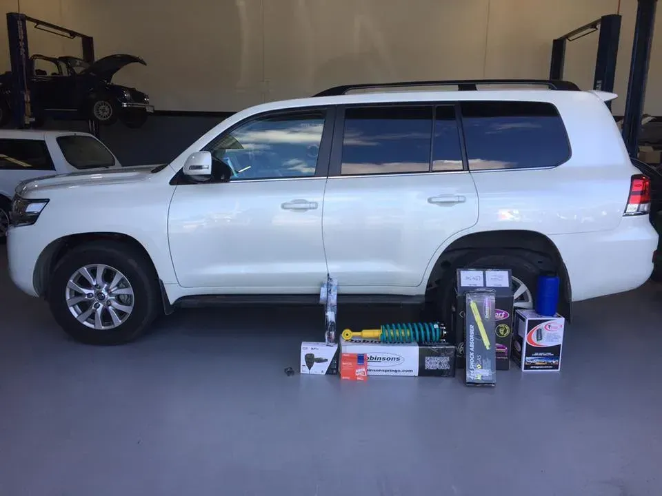 A White SUV is Parked in a Garage Next to a Bunch of Boxes — Browns Autobahn In Nambour, QLD