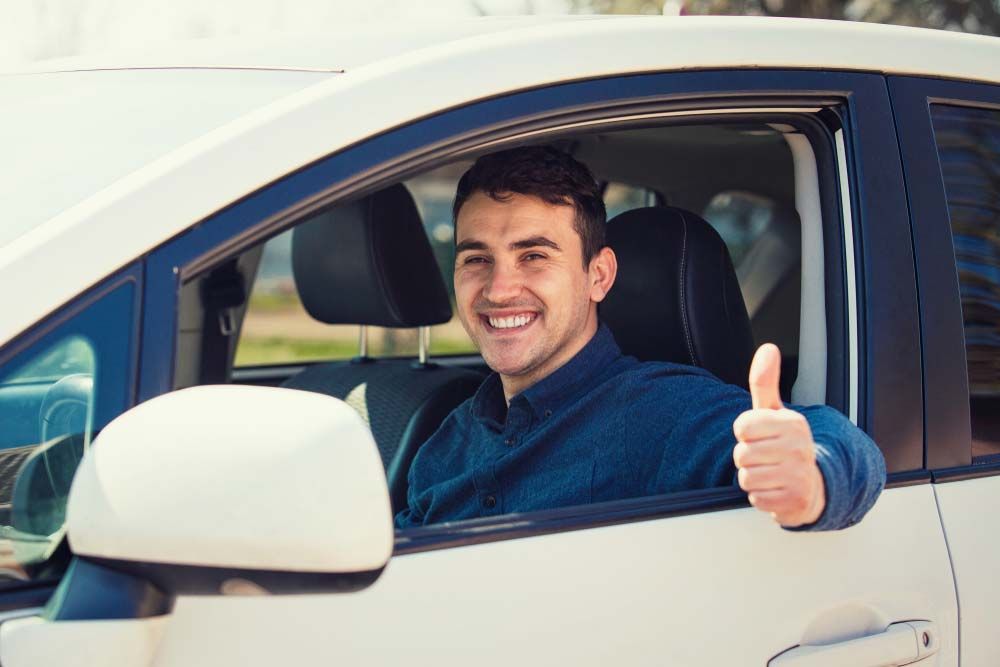 A Man Is Giving A Thumbs Up While Sitting In A Car — Browns Autobahn In Nambour, QLD