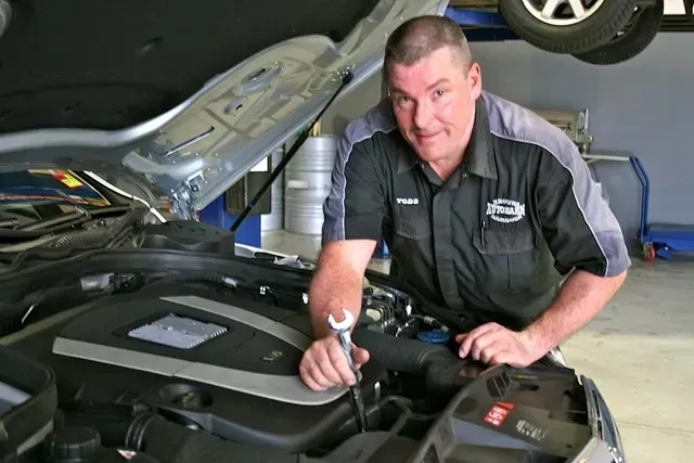 A Man Is Working On The Engine Of A Car — Browns Autobahn In Nambour, QLD