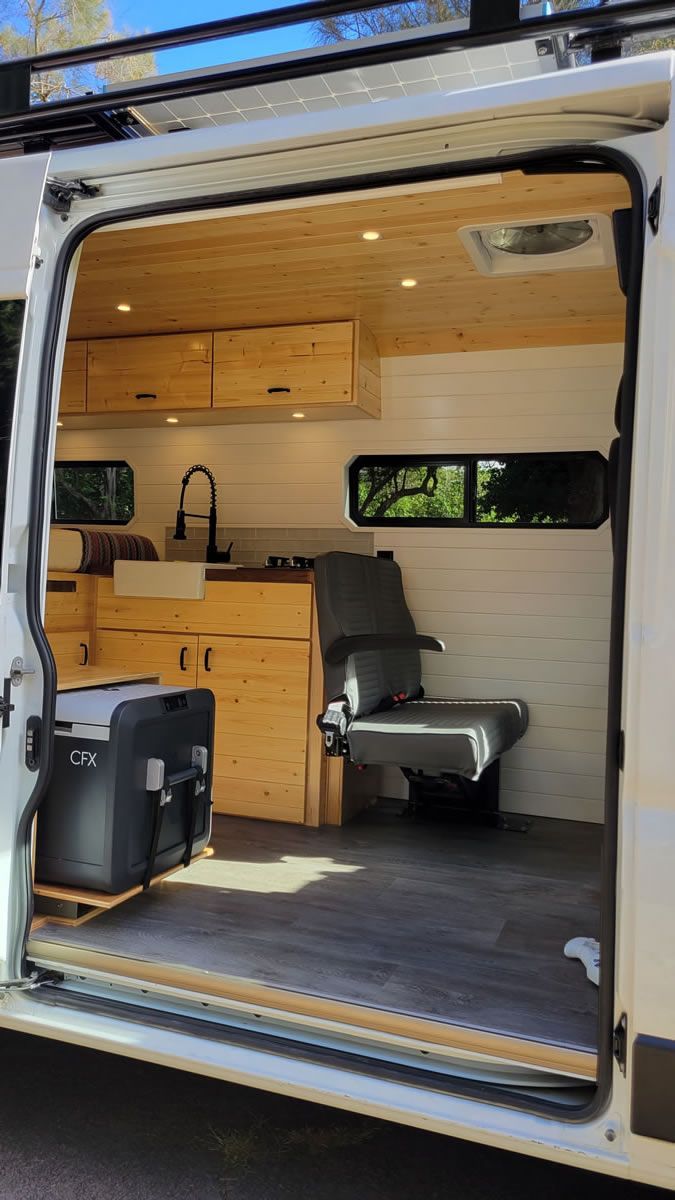 The inside of a camper van with the door open.