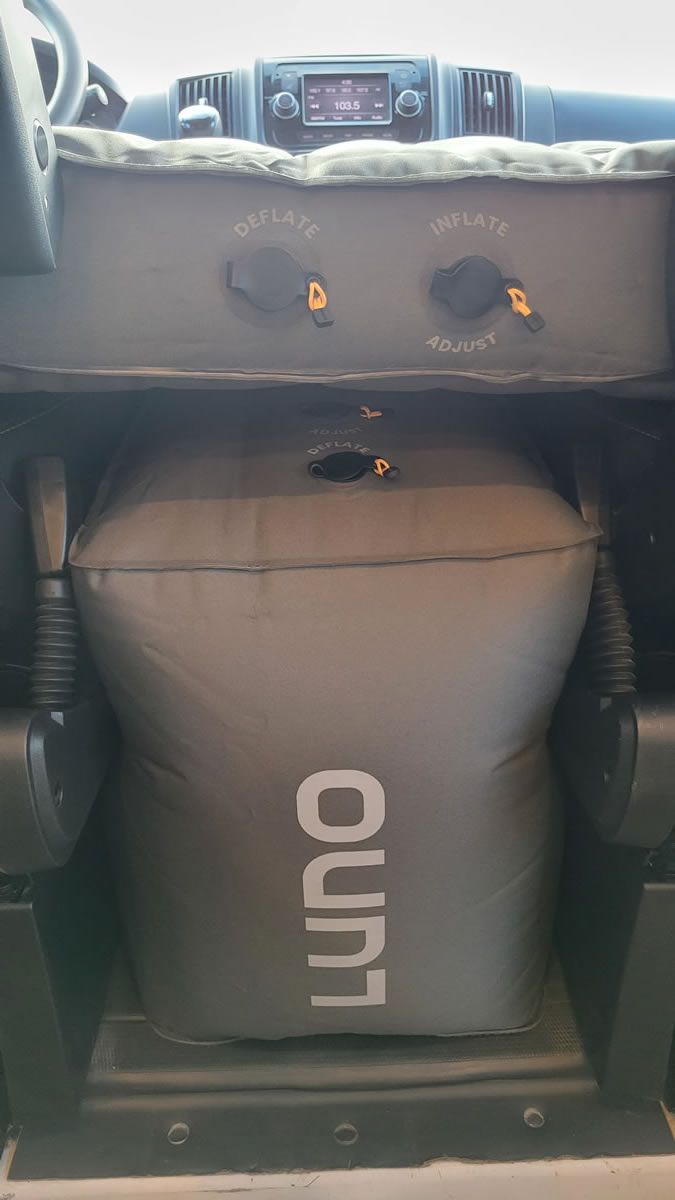 A luggage bag is sitting in the back of a car.