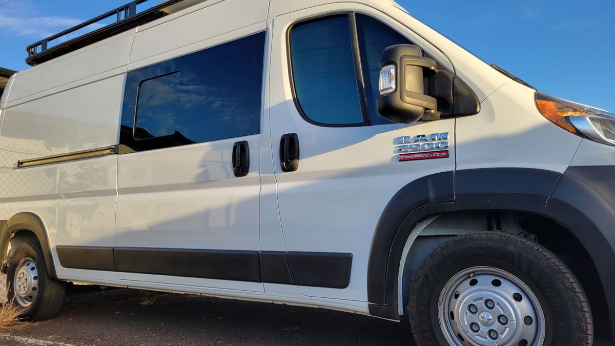 A white van is parked on the side of the road.