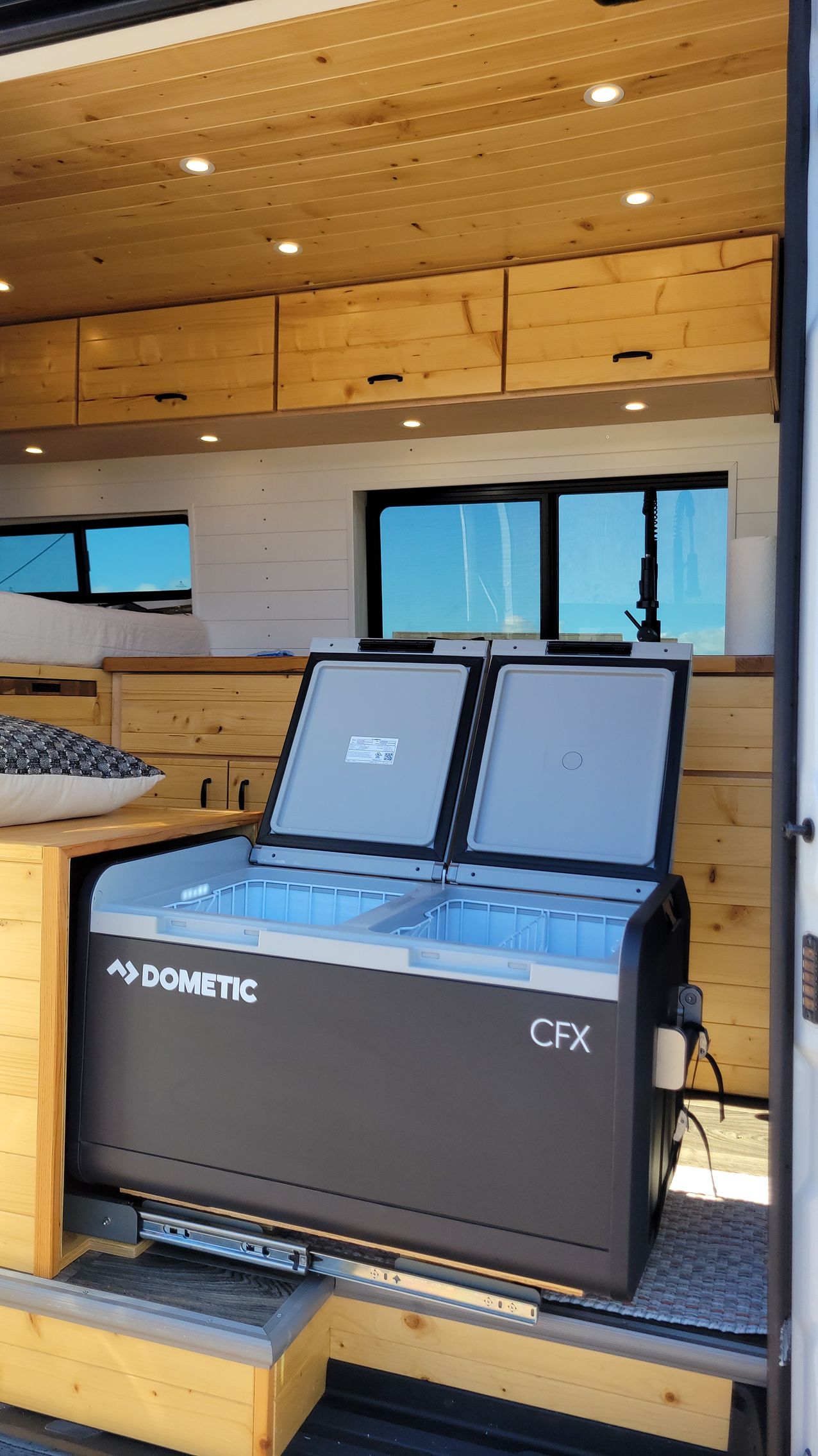 A refrigerator is sitting in the back of a van.