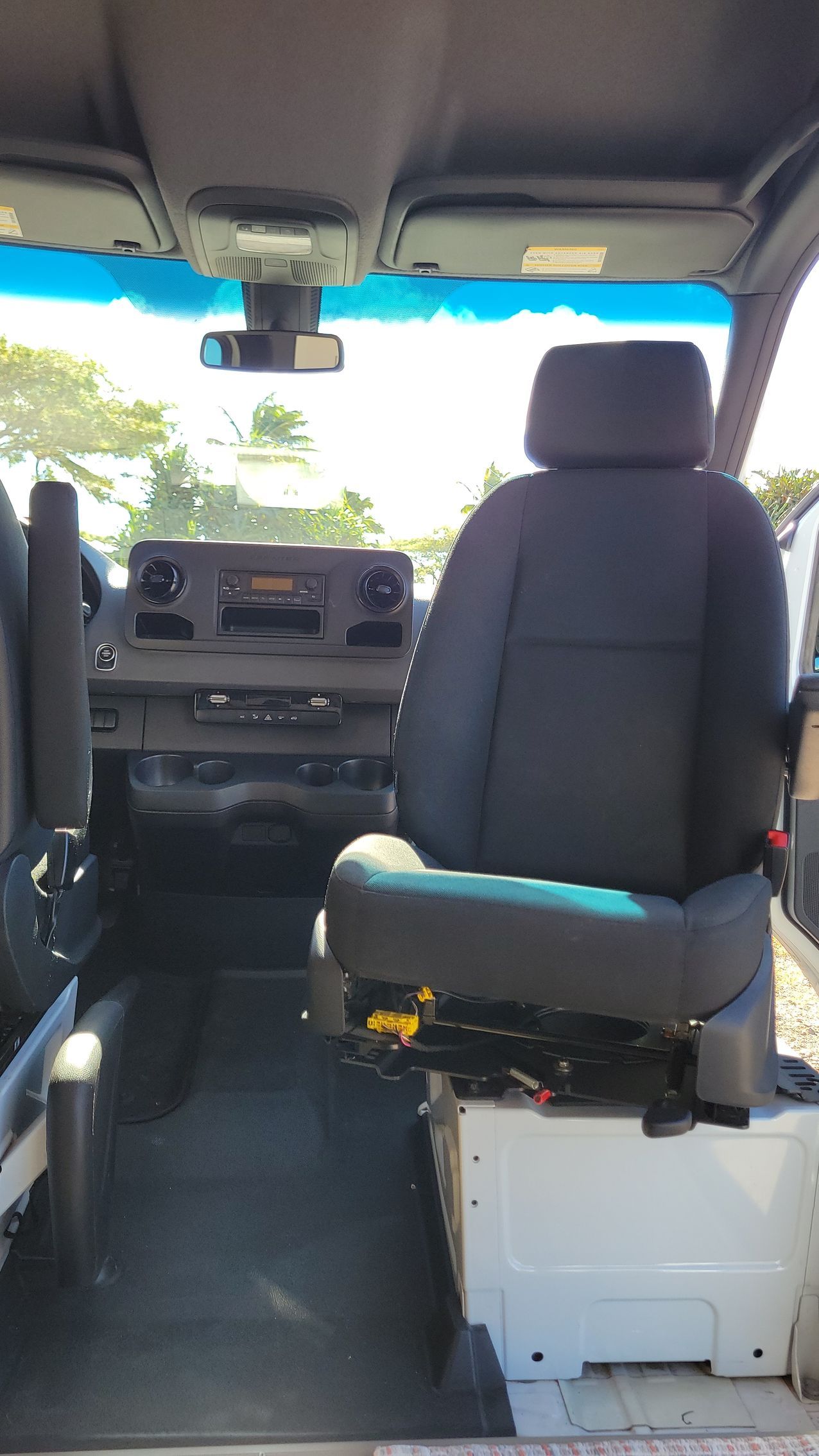 The inside of a van with two seats and a dashboard.
