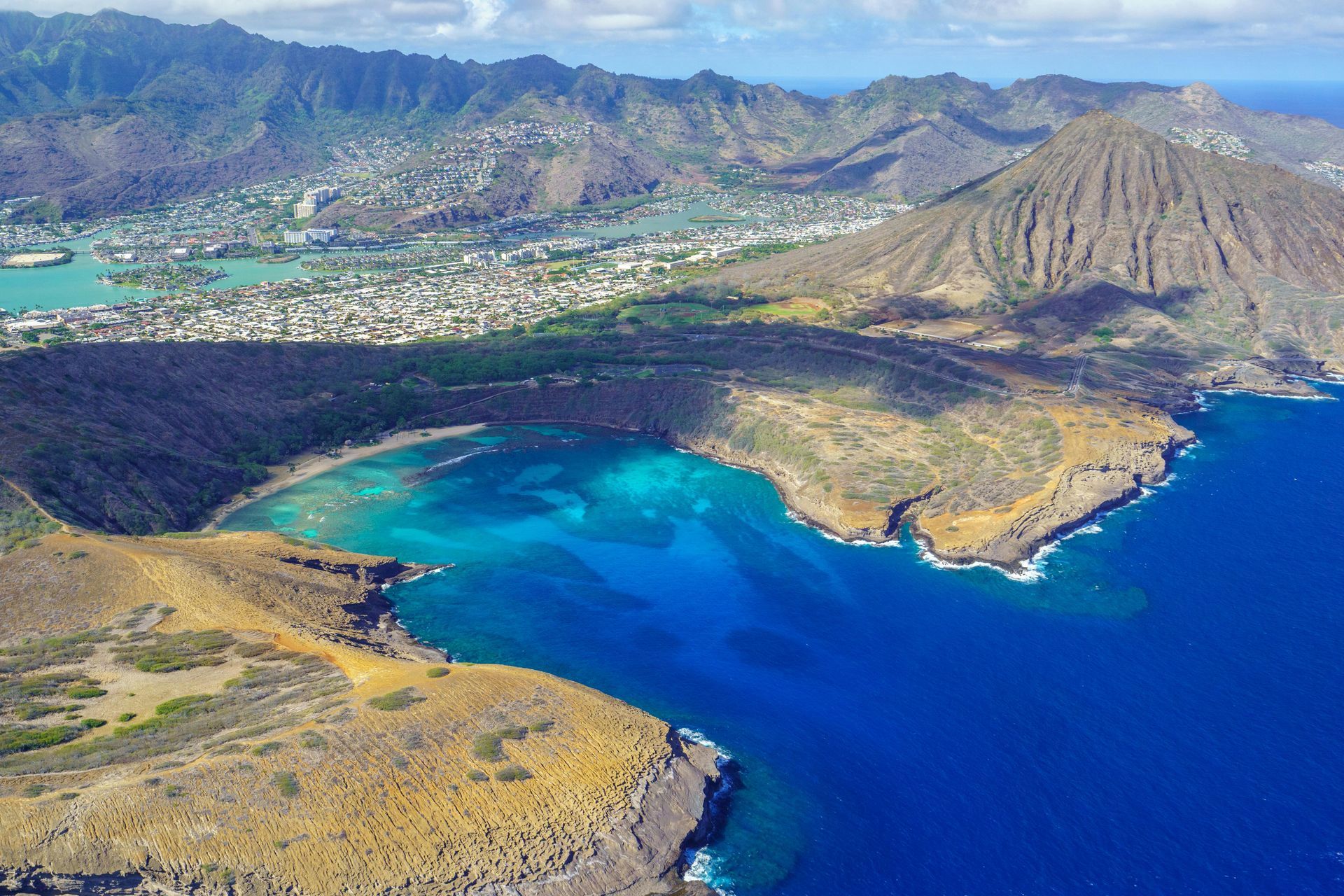 An aerial view of a large body of water surrounded by mountains.