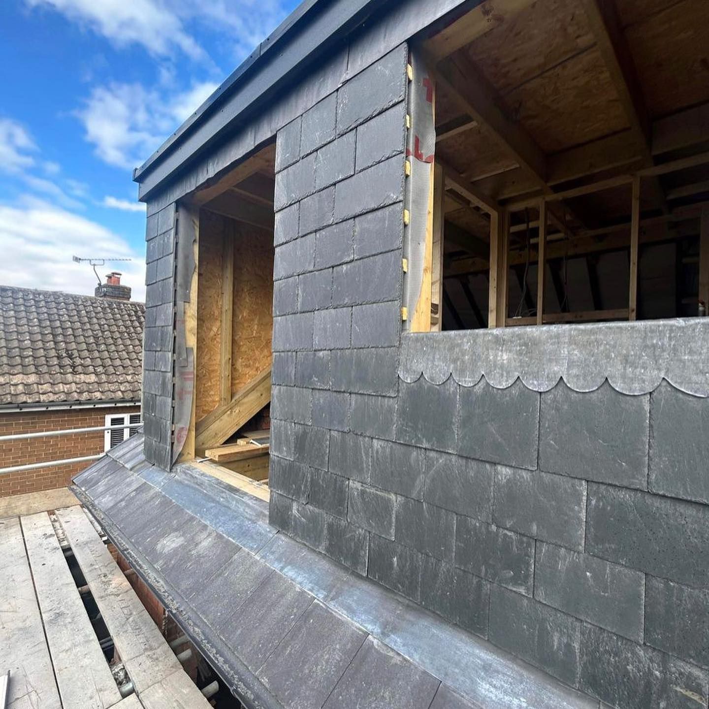 a picture of a slate dormer roof replacement by Hightop roofers Rotherham