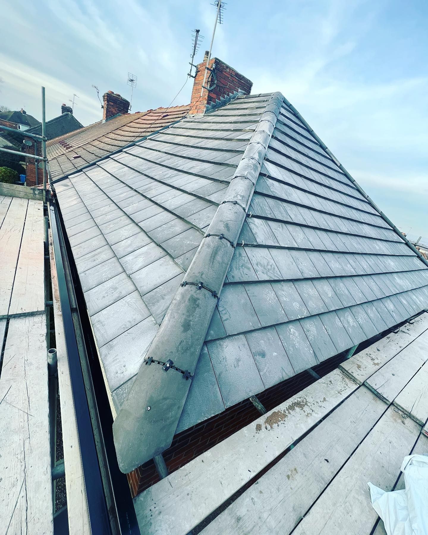 a picture of a hipped roof replacement in grey concrete tile by Hightop roofers Rotherham