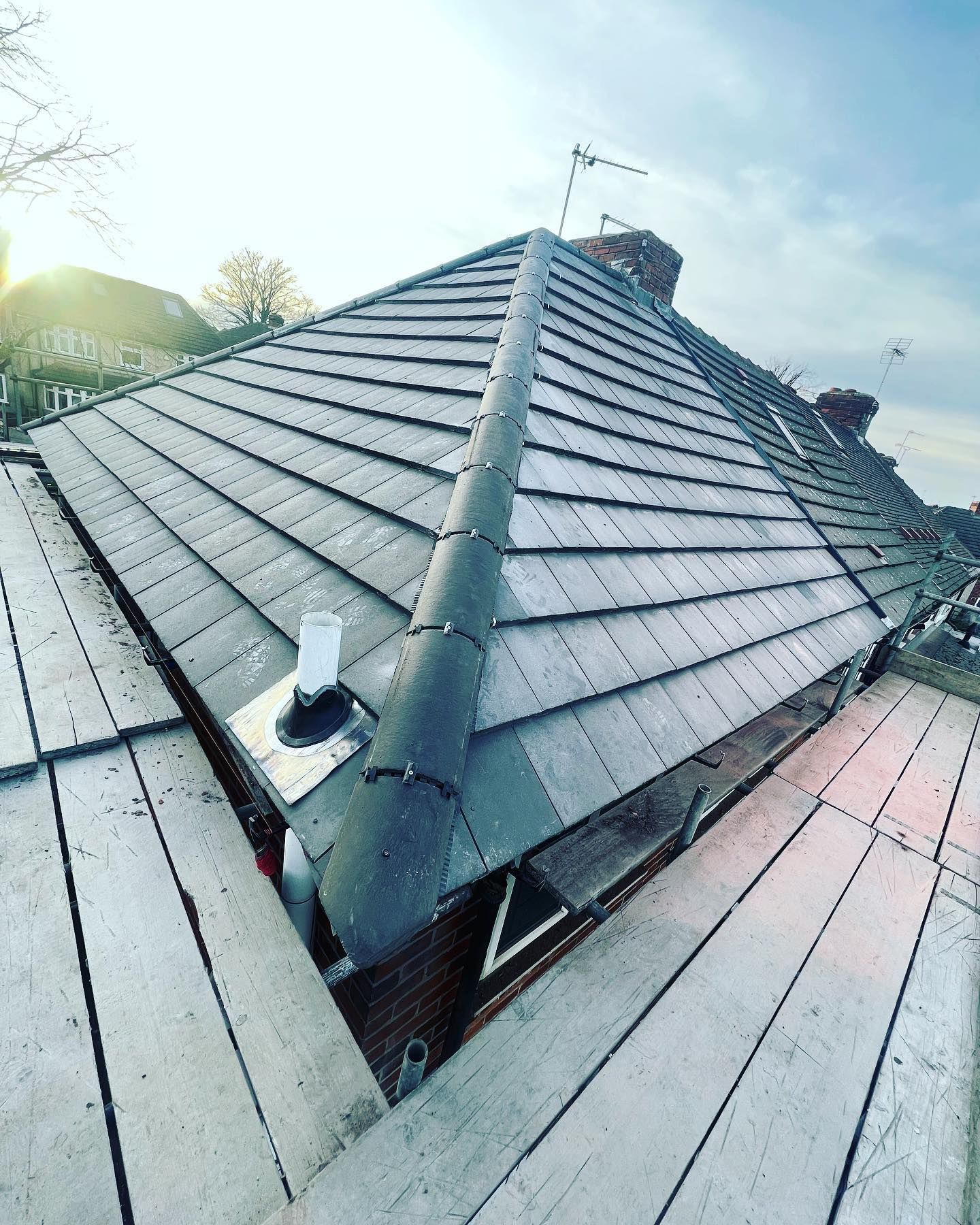 a picture of a new hipped roof replacement grey concrete tile by roofers rotherham