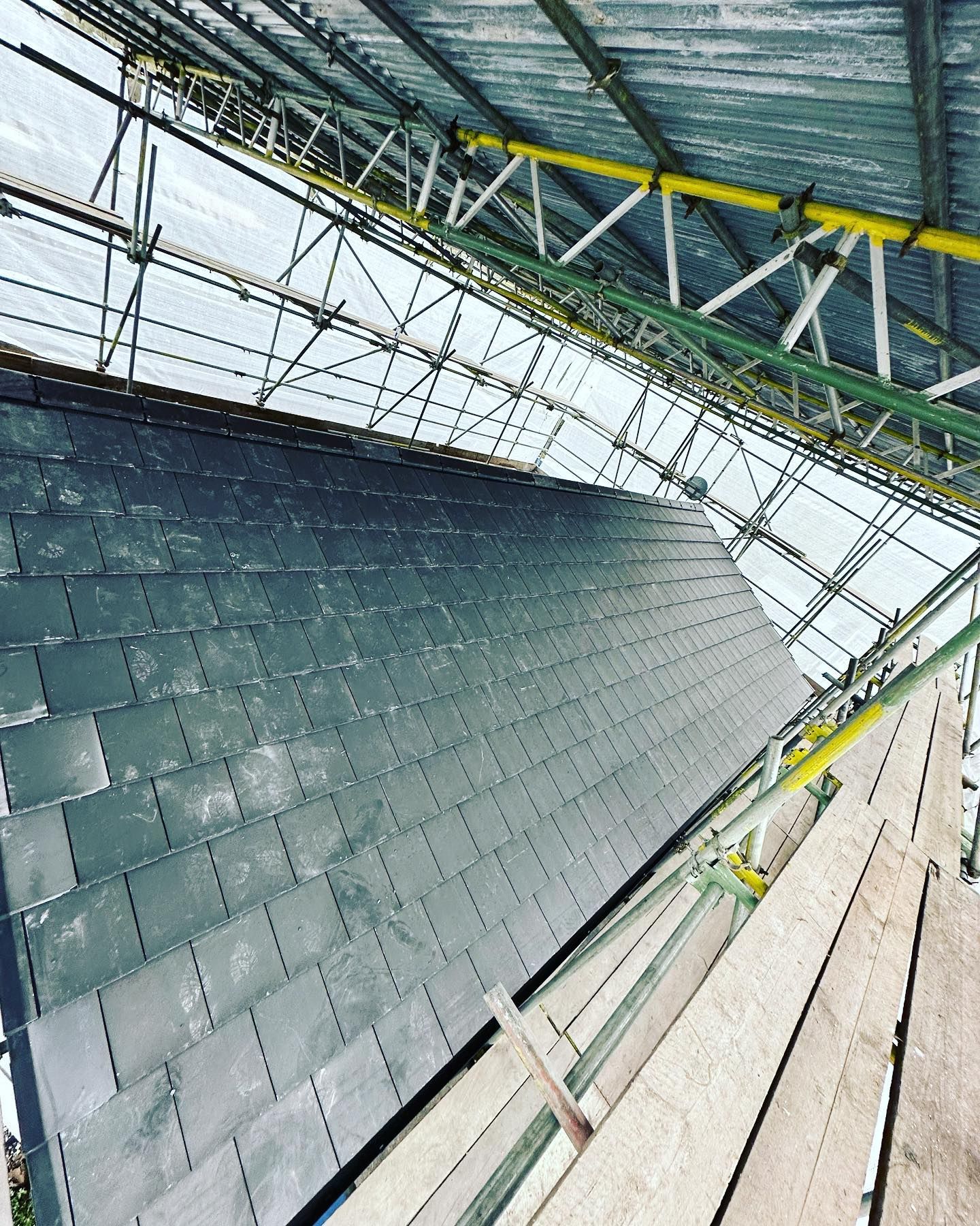 a picture of a slate roof replacement by roofers rotherham
