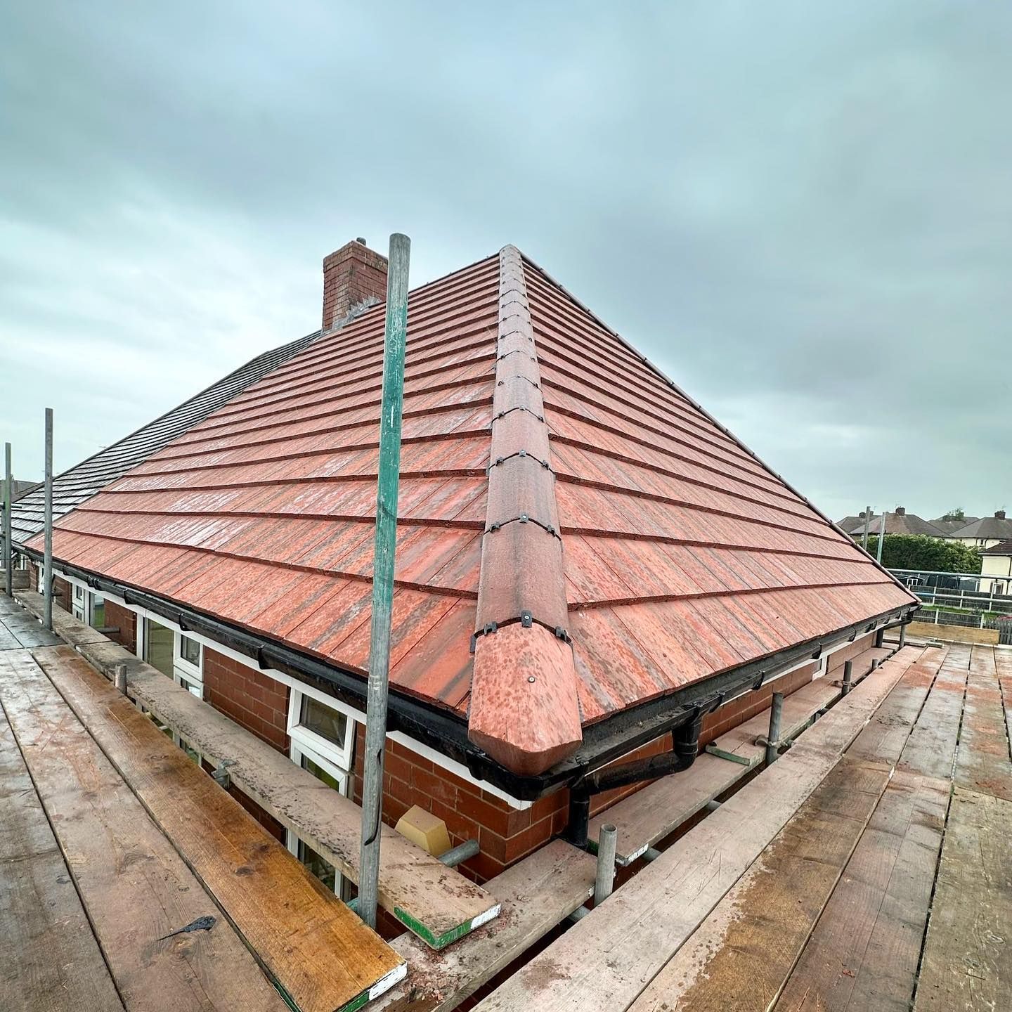 a picture of a new hipped roof in red concrete tile by roofers rotherham