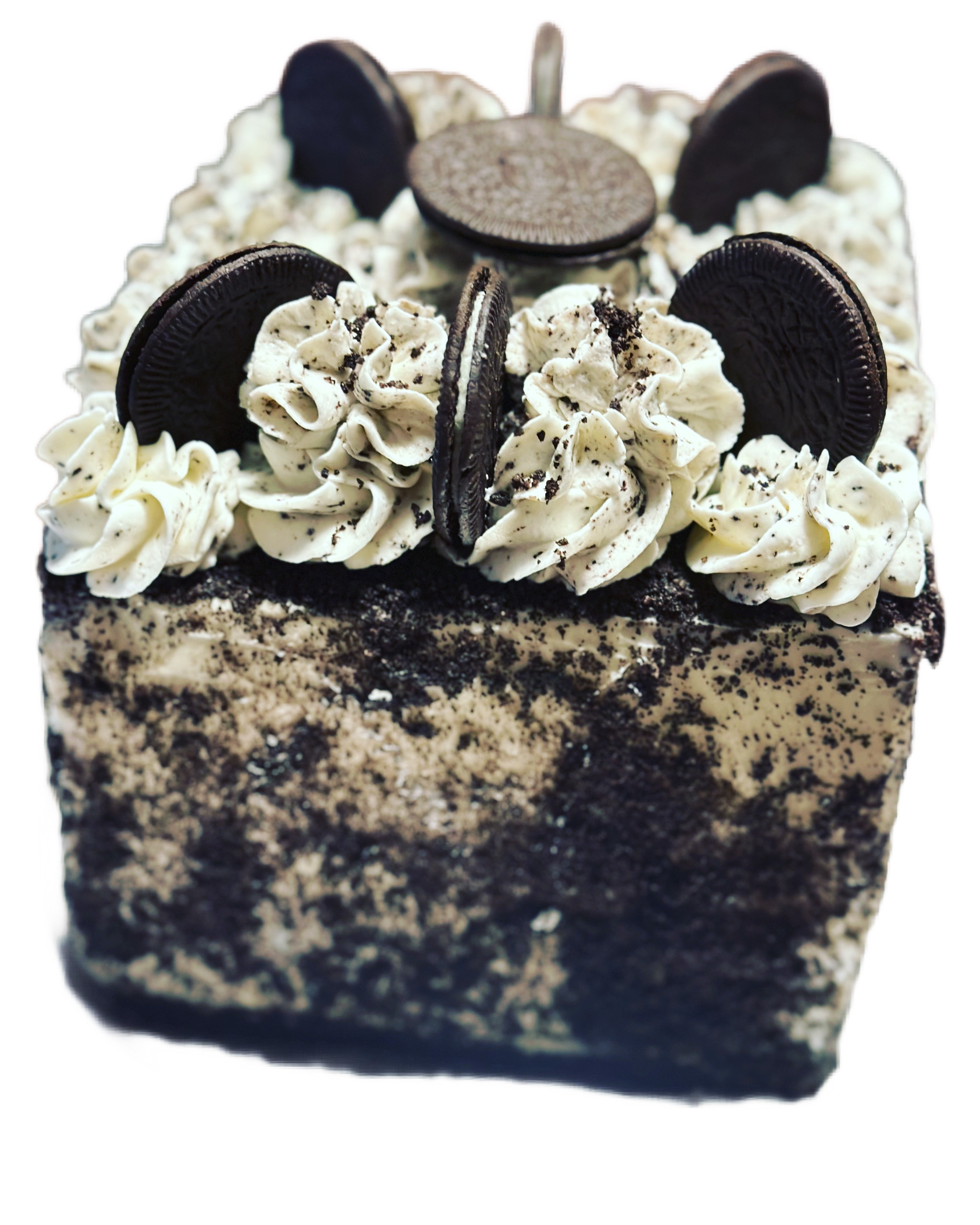 A square cake with oreos and whipped cream on top
