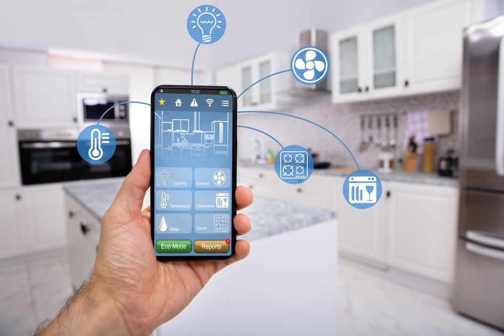 A Hand Holding a Smartphone Controlling Smart Home Devices in a Modern Kitchen — INtelephony In Albury, NSW