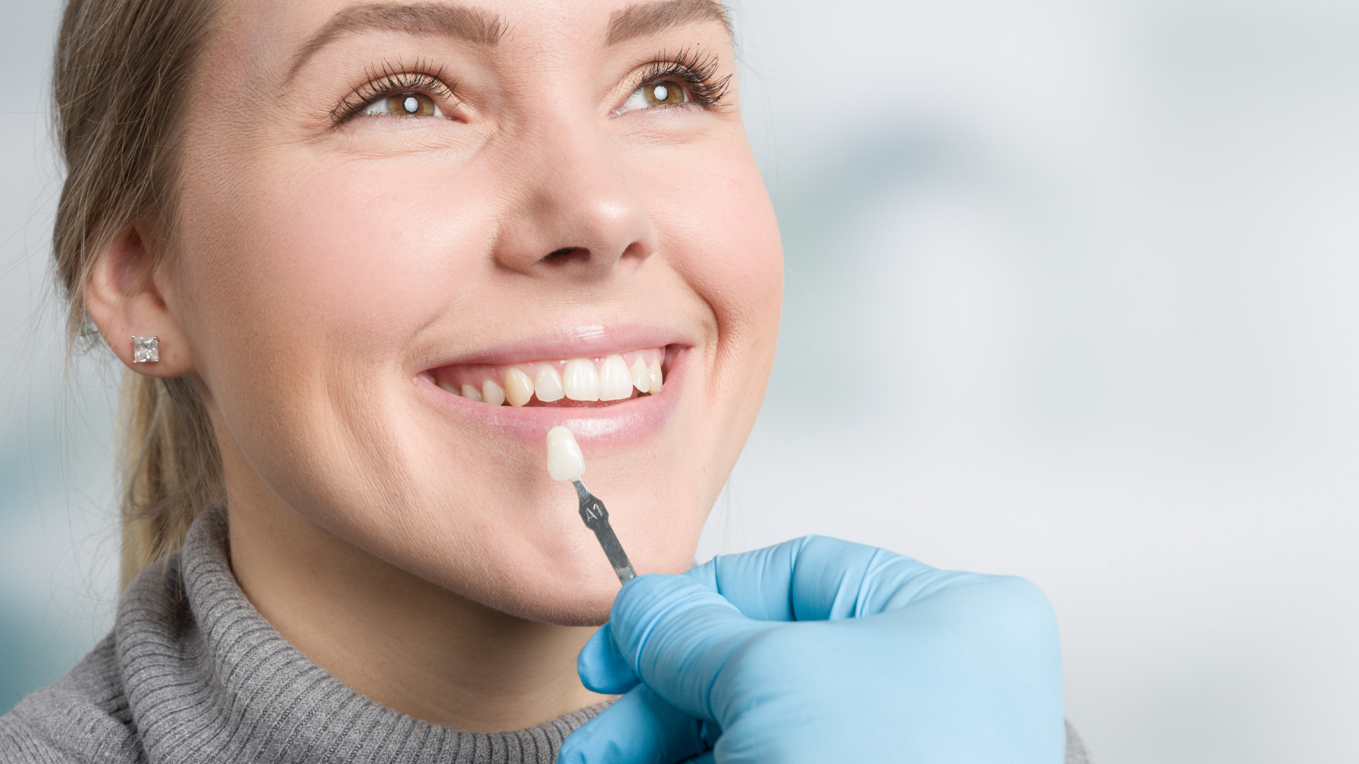 A woman is getting her teeth examined by a dentist.