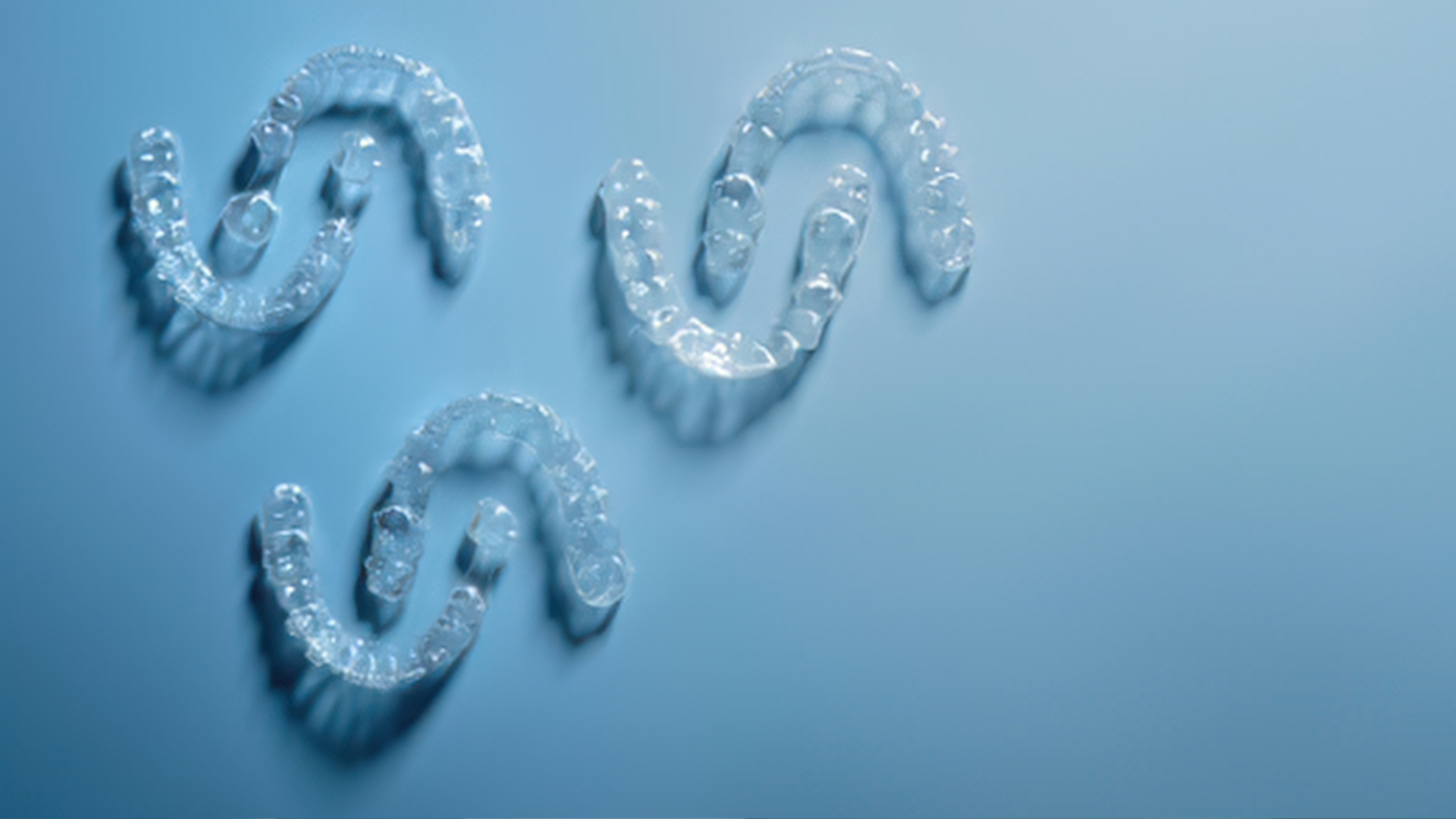 Three translucent blue chain links arranged in a triangle on a light blue background
