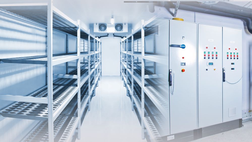 Industrial Cold Storage Room With White Metal Shelving Units on Both Sides — Cool Blue Ice & Water in Singleton, NSW
