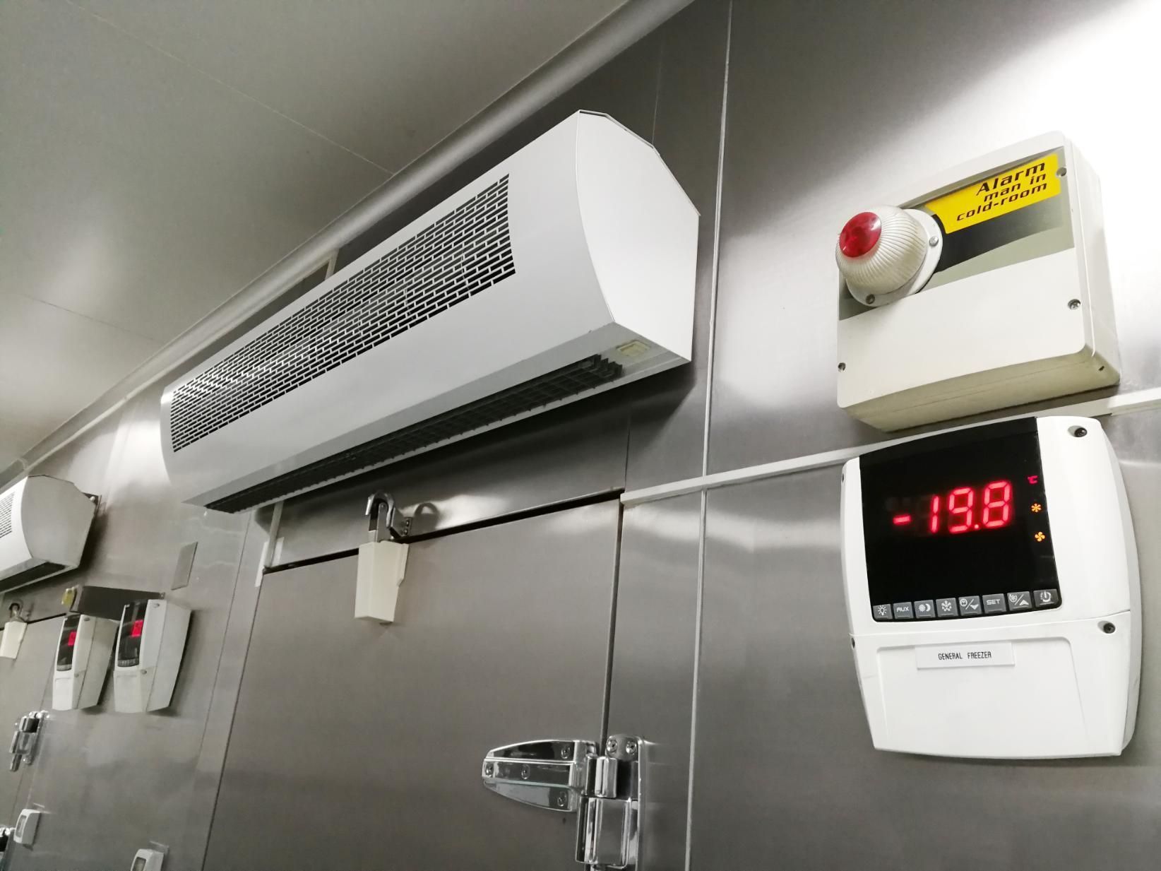 A White Industrial Wall-mounted Air Cooling Unit Next to a Digital Thermostat — Cool Blue Ice & Water in Coolah, NSW