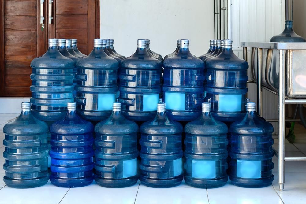 A Group of Large, Blue Plastic Water Jugs — Cool Blue Ice & Water In Lightning Ridge, NSW