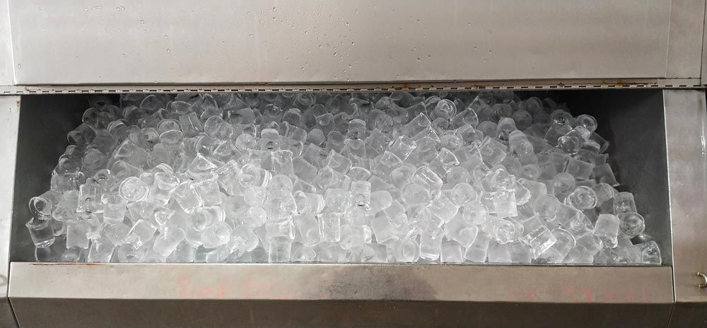 A Stainless Steel Ice Machine Bin Filled With a Large Quantity of Clear, Cubed Ice — Cool Blue Ice & Water in Merriwa, NSW