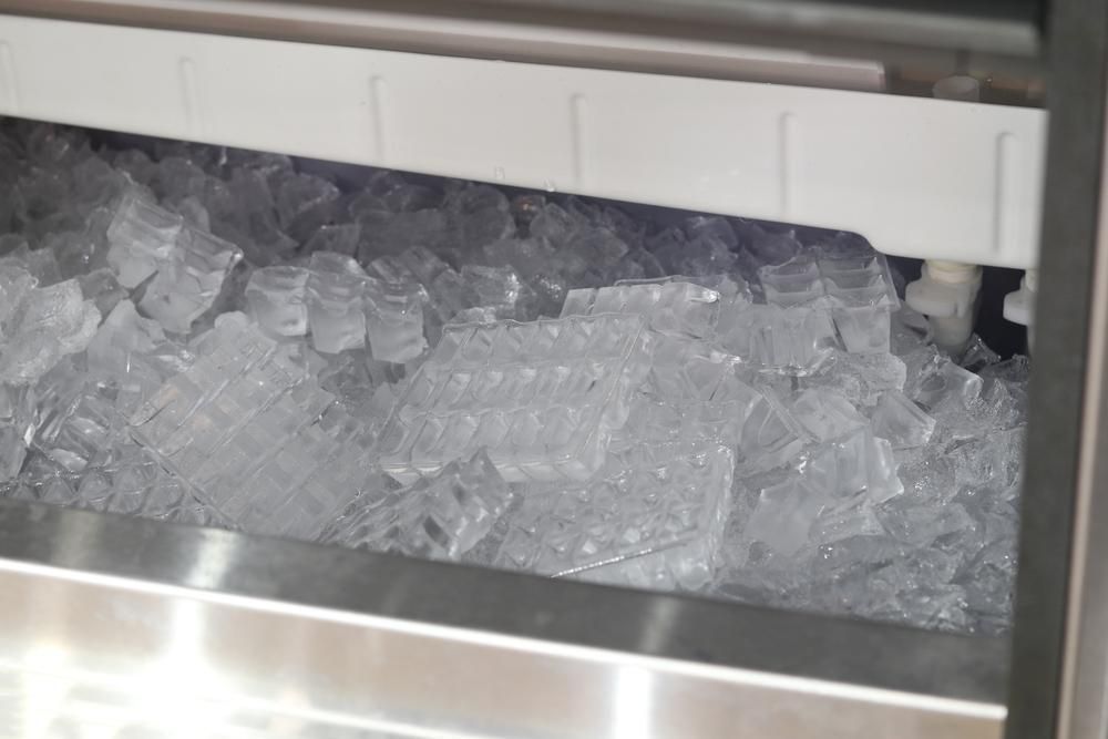 Close-up of a Commercial Ice Machine Bin Filled With Fresh, Clear Ice Cubes — Cool Blue Ice & Water in Parkes, NSW