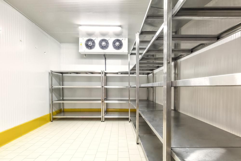 Empty Stainless Steel Shelving Units Inside a Commercial Walk-in Freezer — Cool Blue Ice & Water in Forbes, NSW