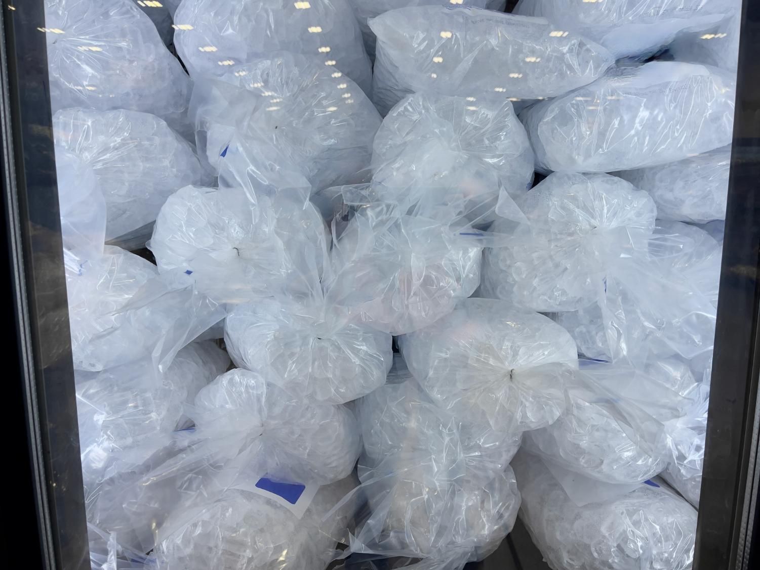 A Large, Vertical Freezer Display Case Tightly Packed With Many Bags of Ice — Cool Blue Ice & Water in Walgett, NSW