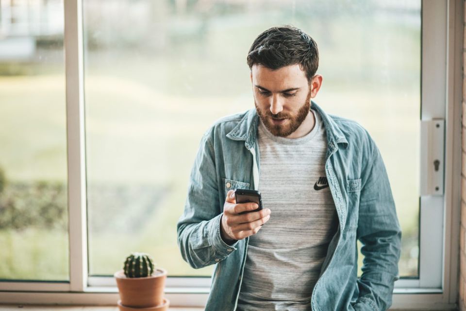 Man Looking at His Phone | Manteca, CA | Legacy Local Impact