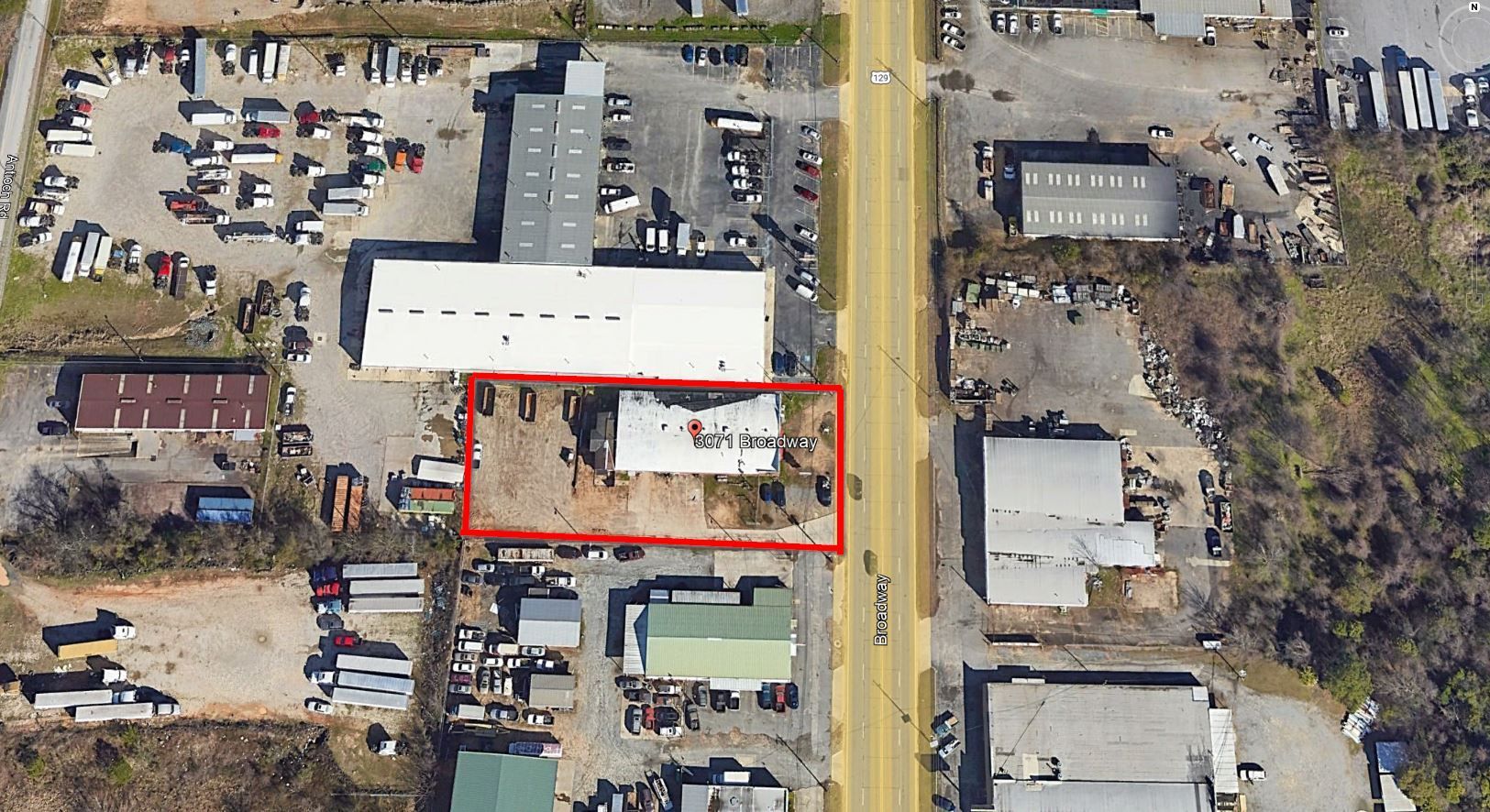 An aerial view of a building with a red outline around it