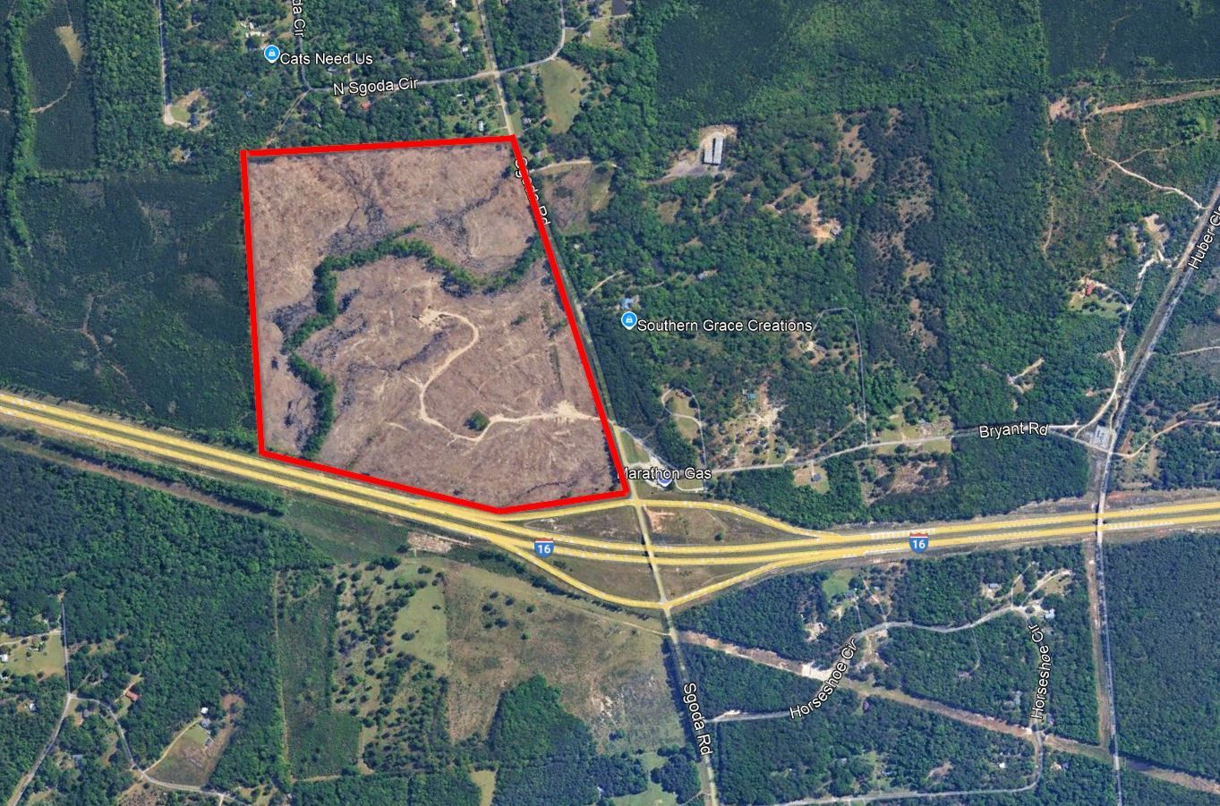 An aerial view of a residential area with a red outline around it.