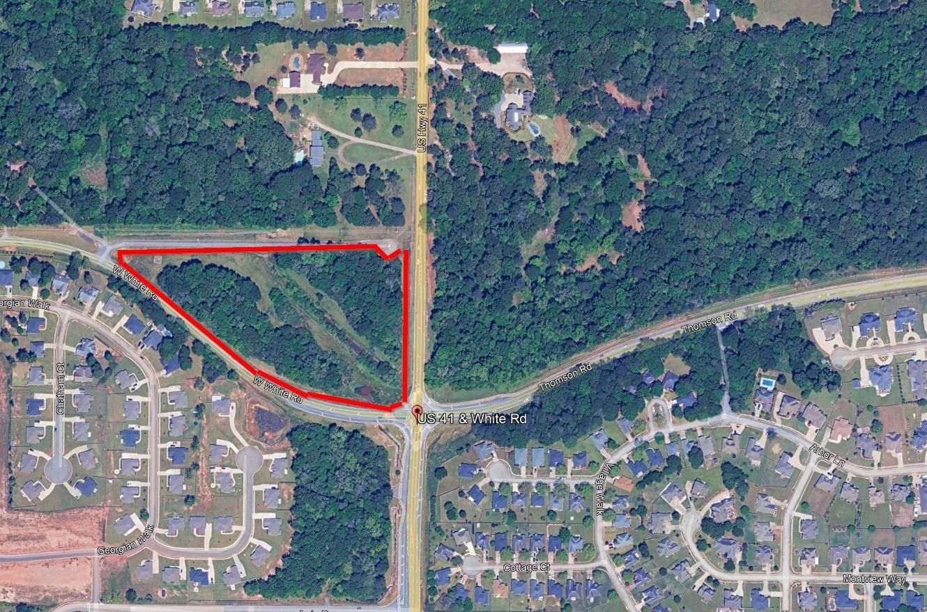 An aerial view of a residential area with a red circle in the middle.