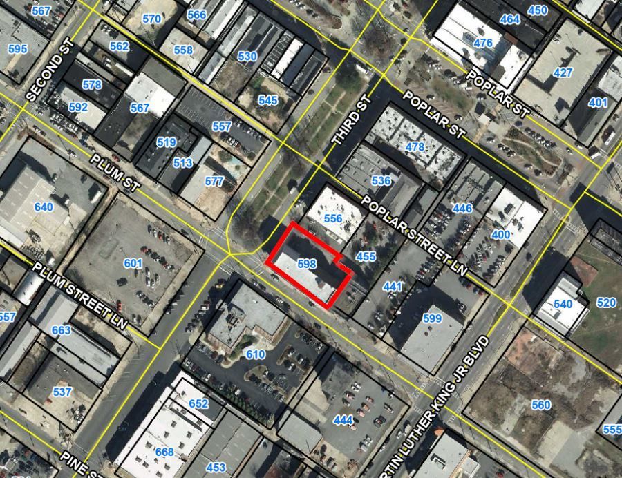 An aerial view of a city with a red building in the middle