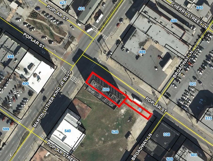 An aerial view of a city with a red area in the middle