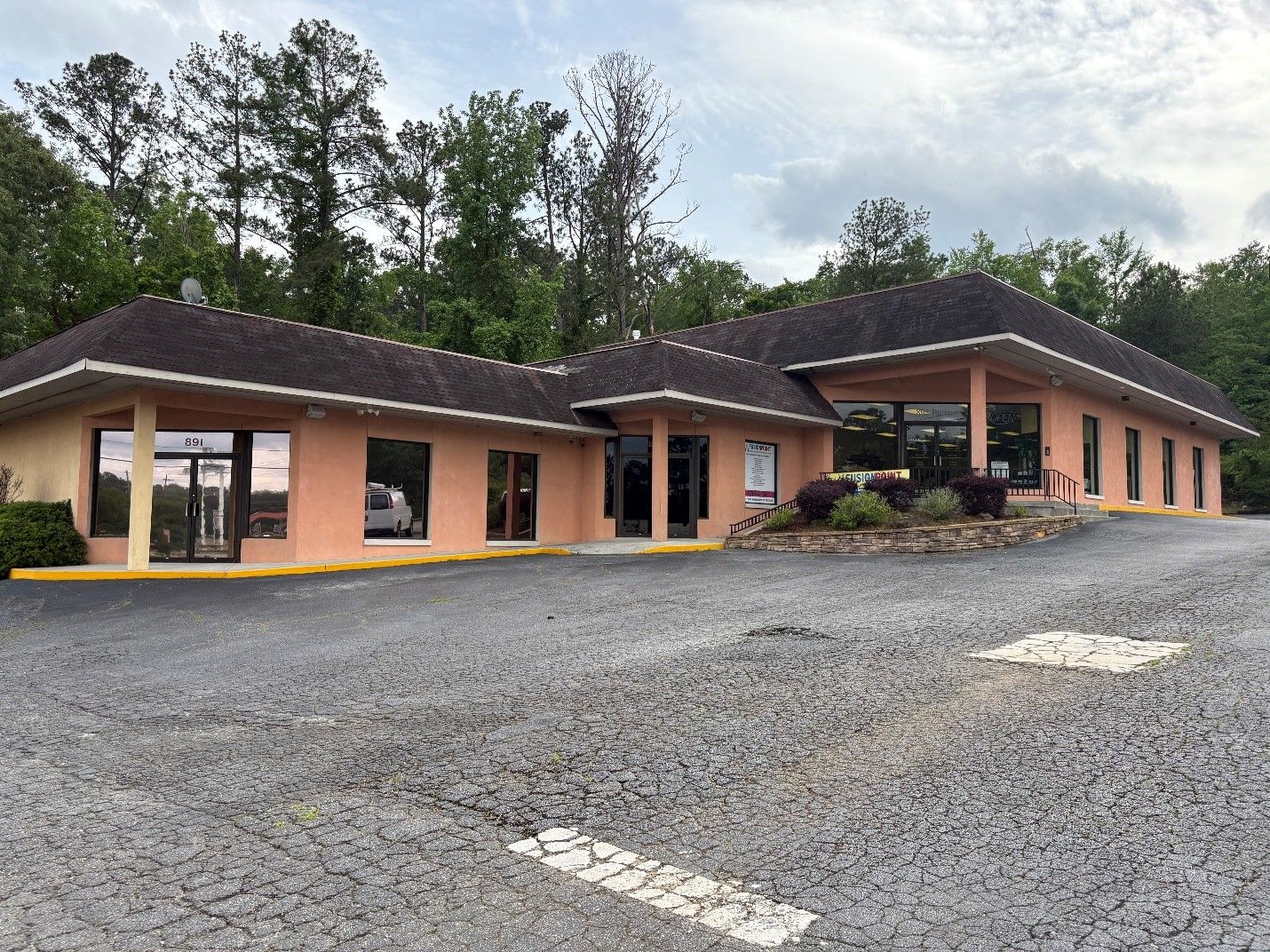 A large building with a parking lot in front of it