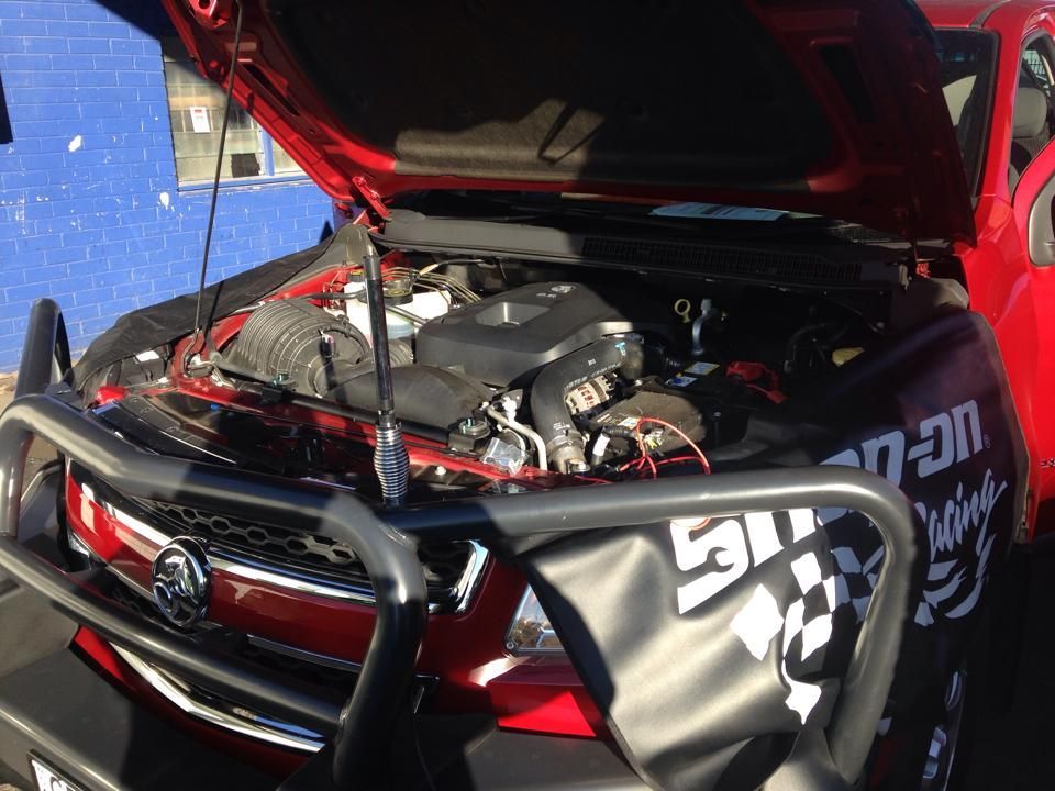 Red Car Engine Bay With the Hood Open — Gibbo's Auto Electrics & Air Conditioning Services in Maitland, NSW