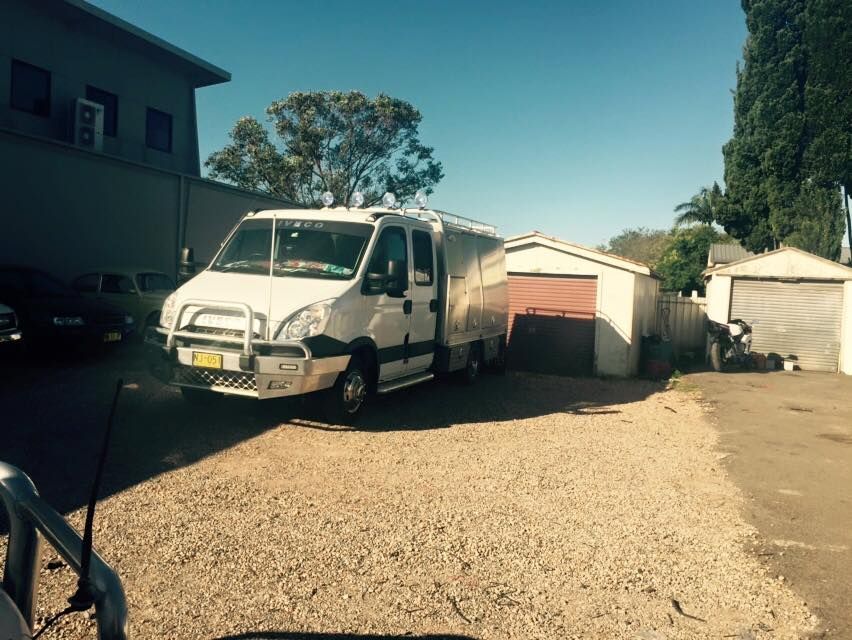 White Van Parked in a Gravel Lot — Gibbo's Auto Electrics & Air Conditioning Services in Newcastle, NSW
